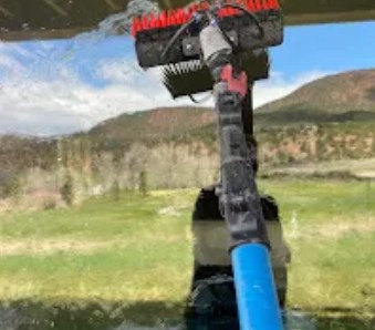 Brush head on a pole against a mountain view